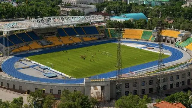 Aerial view of a soccer stadium with players on the field in Kairat, Almaty.