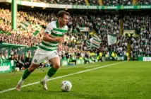 Kieran Tierney in Celtic kit running with determination on the pitch