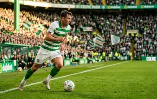 Kieran Tierney in Celtic kit running with determination on the pitch