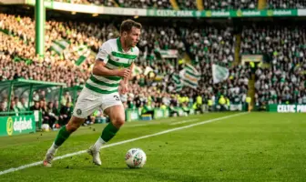 Kieran Tierney in Celtic kit running with determination on the pitch