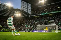 Celtic penalty kick moment under floodlights with tense crowd atmosphere at Scottish football stadium
