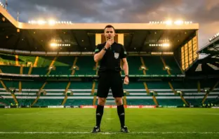 Football referee in black uniform with headset standing authoritatively on stadium pitch under dramatic lighting
