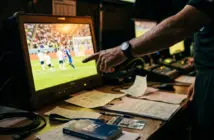 Referee reviewing VAR monitor during match controversy investigation