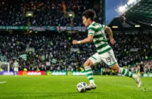 Celtic winger Yang Hyun-jun sprinting with ball in green and white hooped jersey at Celtic Park
