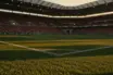 Floodlit World Cup stadium at dusk with Algerian and Austrian national colors in the stands and dramatic field lighting.