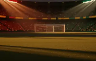 Floodlit stadium at golden hour with packed stands, dramatic shadows, and red-gold and green-gold lighting reflecting Belgium vs. Senegal colours.