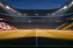Floodlit stadium at dusk with Croatian red-white and Ghanaian gold-red-green flag colours illuminating packed stands above empty pitch.