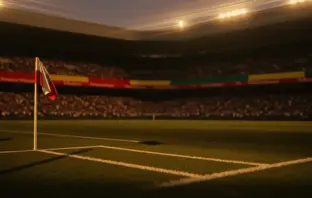 Floodlit football stadium at sunset with packed stands, empty pitch, and gold-hour atmospheric lighting