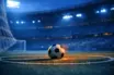 Floodlit stadium pitch at dusk with match ball on centre spot, cool blue ambient lighting creating dramatic shadows, corner flag perspective.