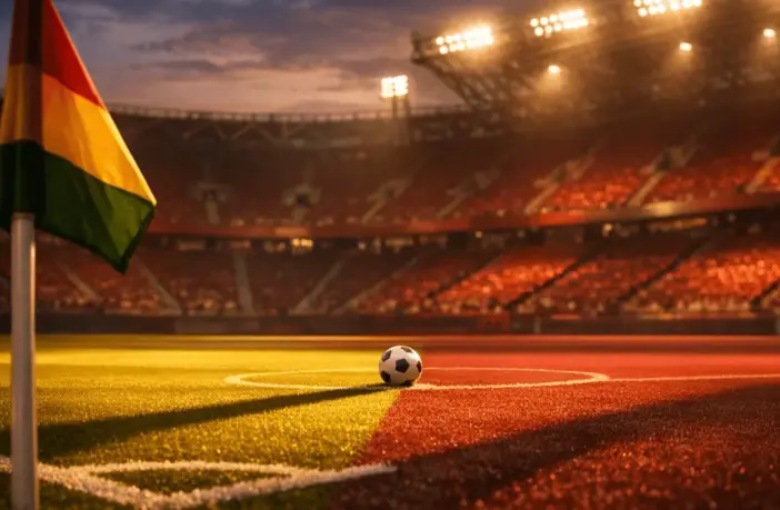 Empty floodlit stadium pitch corner view at dusk, gold and burgundy lighting, match ball on centre spot, sharp shadows.