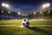 Empty floodlit football pitch with ball on penalty spot, dramatic stadium lighting and long shadows, cinematic sports photography