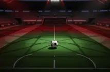 Aerial stadium view of floodlit pitch with match ball on centre circle, red-green colour accent lighting, evening kick-off atmosphere.