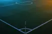 Floodlit football pitch at dusk with geometric markings and dramatic stadium shadows, anticipatory pre-match atmosphere.