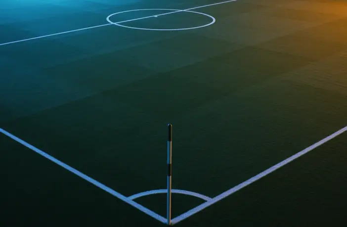 Floodlit football pitch at dusk with geometric markings and dramatic stadium shadows, anticipatory pre-match atmosphere.