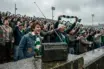 Vintage transistor radio on football terrace with Celtic supporters in background, May 1986