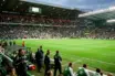 Celtic Park stadium view from dugout with green pitch and supporters in 2000