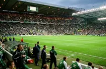 Celtic Park stadium view from dugout with green pitch and supporters in 2000