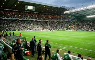 Celtic Park stadium view from dugout with green pitch and supporters in 2000