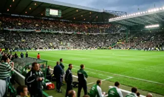 Celtic Park stadium view from dugout with green pitch and supporters in 2000