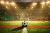 Floodlit football pitch at dusk with red and green stadium lighting, ball on centre circle, dramatic shadows.