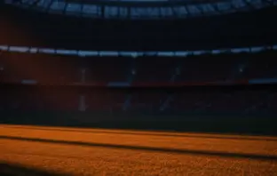 Empty floodlit stadium at dusk with dramatic shadow patterns, atmospheric crowd silhouettes in stands, cinematic sports photography lighting.