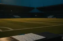 Empty football stadium at dusk with tactical board, symbolizing pre-season preparation urgency