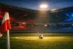 Floodlit empty football pitch at dusk with Panama flag-coloured lighting accents, ball on centre spot, dramatic shadows.