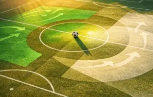 Abstract aerial pitch view with Saudi Arabian flag colours, tactical overlays, and centre-circle football at golden hour.