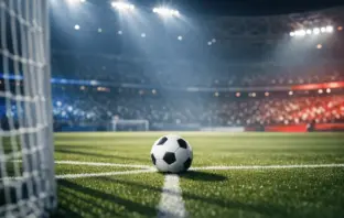 Floodlit football pitch with match ball on centre spot at night, ready for kickoff. Empty stadium stands under dramatic shadows.