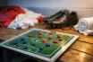 Tactical preparation scene: locker-room bench with US-coloured kit, boots, towels, and pitch diagram magnets in dramatic lighting.