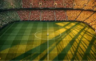 Stadium aerial view with floodlit pitch, packed colourful stands, and centered match ball under evening lights.
