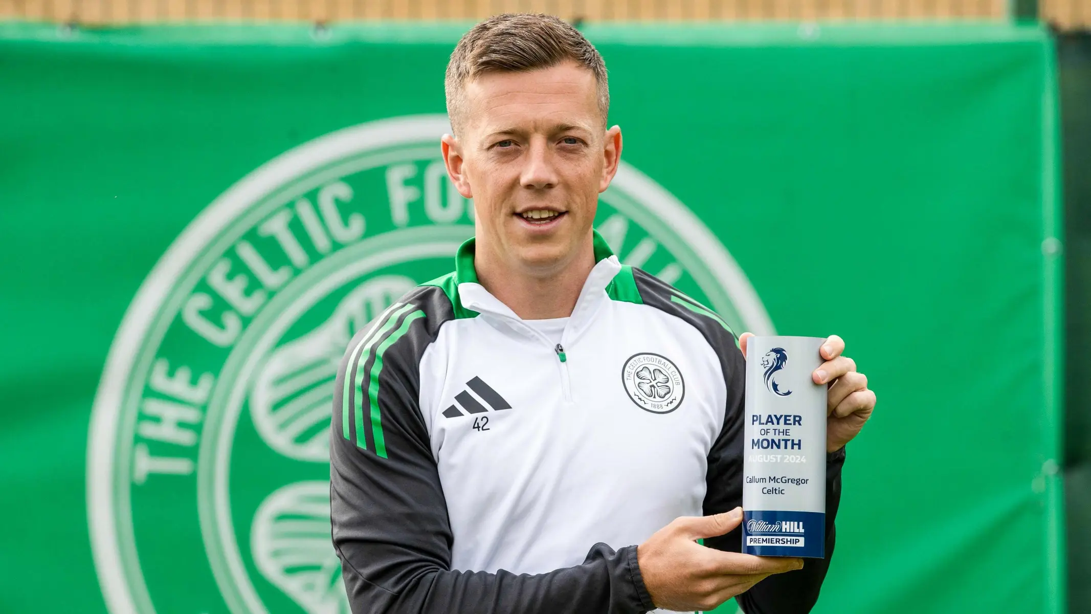 Callum McGregor holding his Player of the Month award for Celtic.
