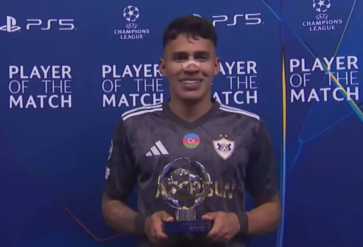 Camilo Duran holding a Player of the Match trophy after a game.