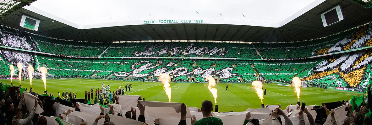 Celtic Park stadium filled with fans during a match, showcasing green and white colors.