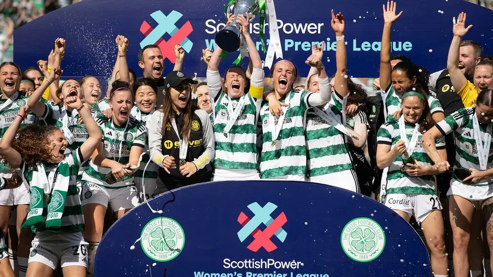 Celtic FC Women celebrating victory with trophy and medals.