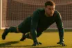Goalkeeper making athletic save in green kit representing Celtic transfer target Tjark Ernst