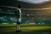 Football striker silhouette in Celtic green hooped jersey at Celtic Park stadium choosing to stay