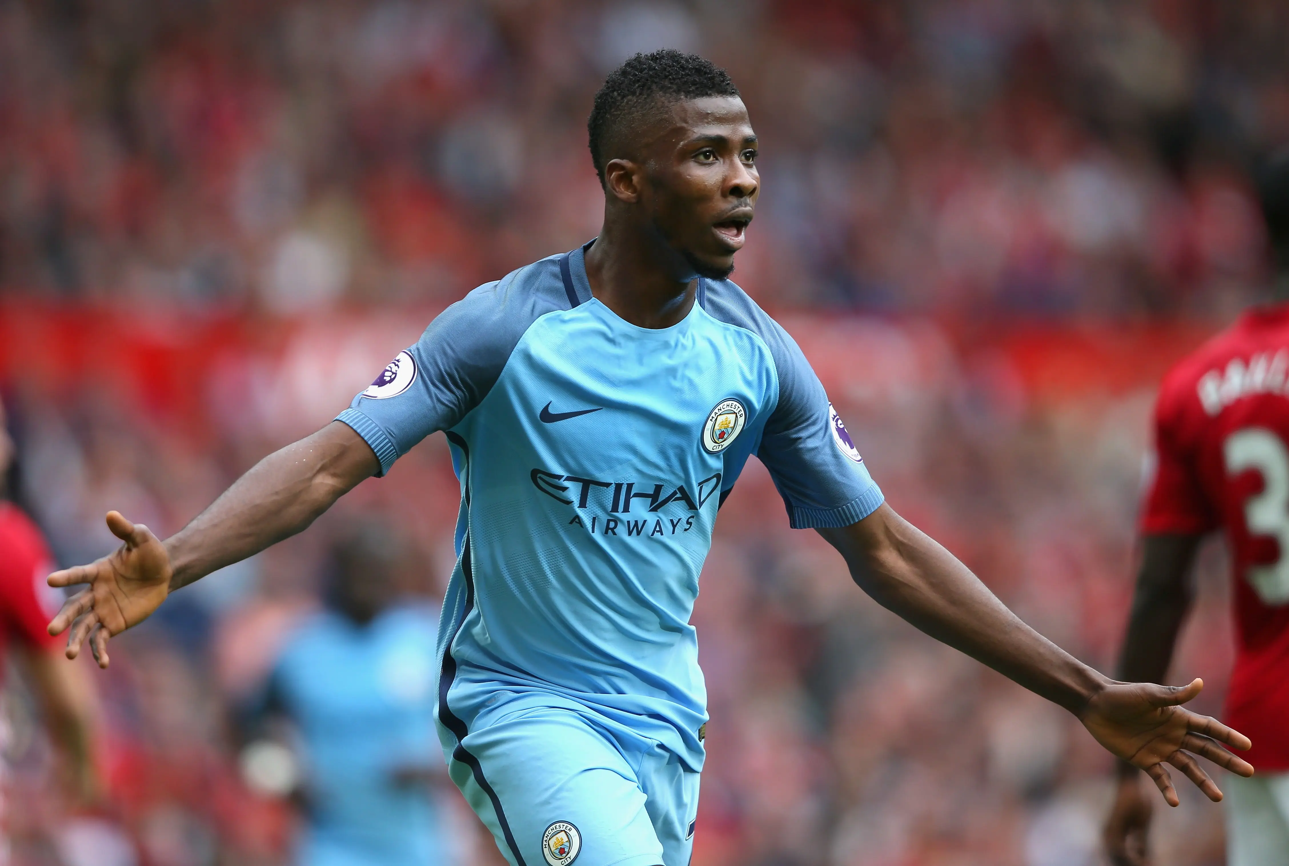 Kelechi Iheanacho celebrating a goal during a football match in a sky blue Manchester City kit.