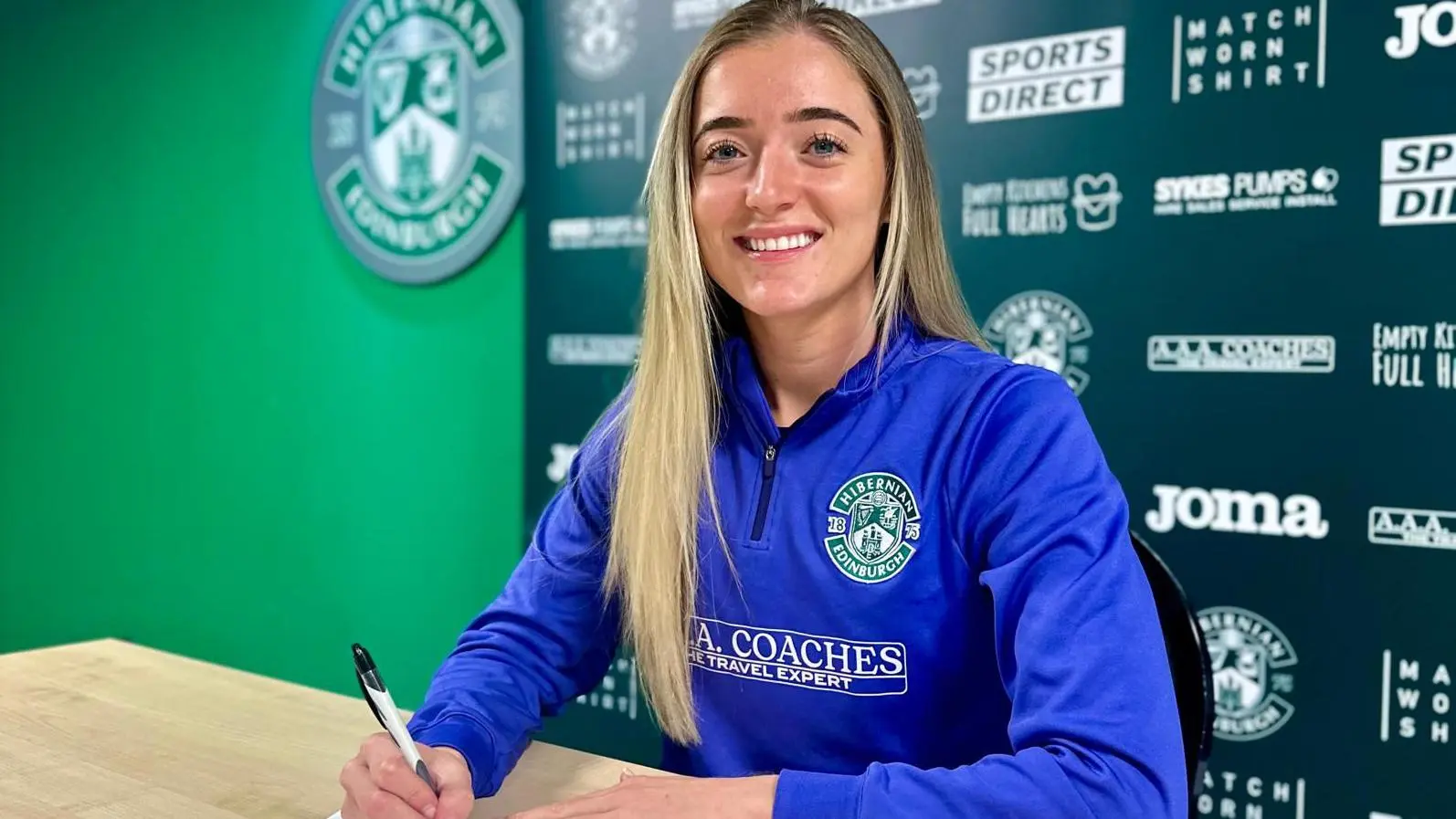 Lauren Doran-Barr signing at Hibernian Women's team office.