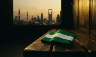 Celtic captain armband on locker bench with Saudi cityscape in background