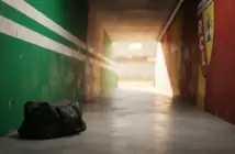 Football stadium tunnel transitioning from Celtic green to Ligue 1 colours representing player transfer