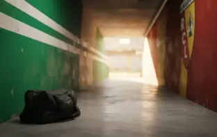 Football stadium tunnel transitioning from Celtic green to Ligue 1 colours representing player transfer