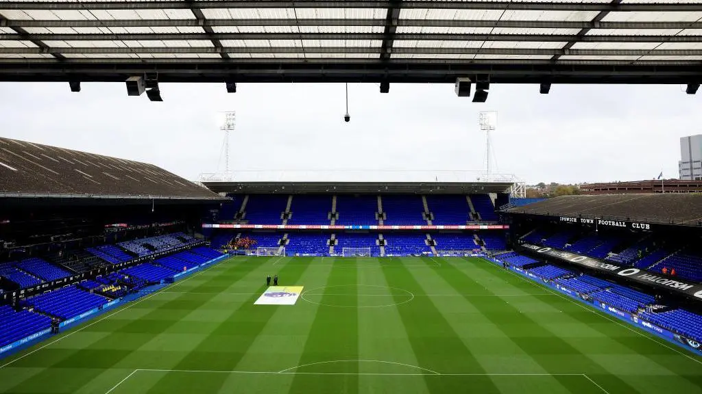 Wide view of the blue seating and green pitch at Portman Road stadium, home of Ipswich Town FC