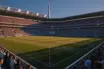 World Cup Round of 16 stadium atmosphere: floodlit pitch, packed stands, dramatic shadows, golden-hour lighting.