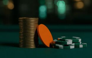 Gold £1 coins stacked beside green and white casino chips on dark felt — best £1 deposit casinos UK guide 2026