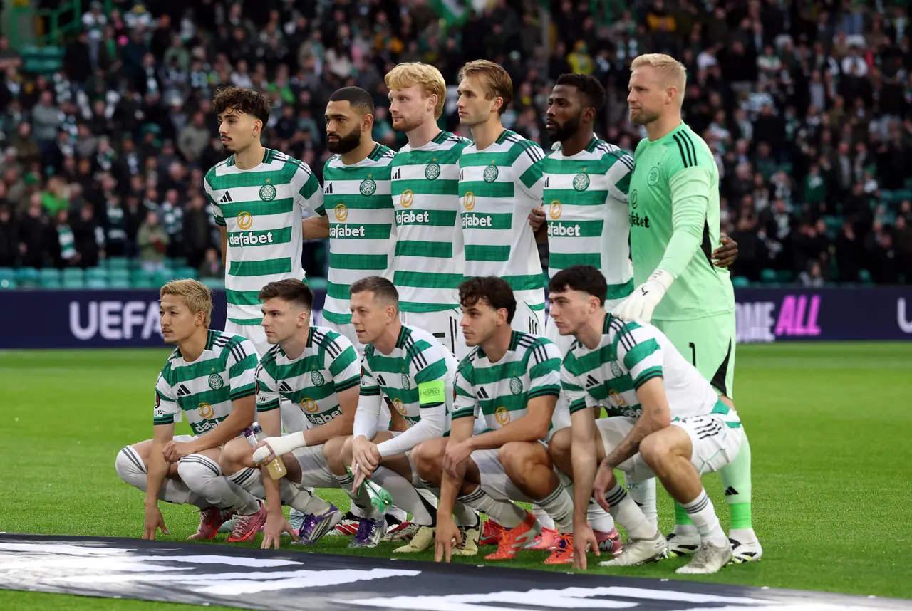 Celtic FC starting eleven posing for a team photo on the pitch with UEFA branding in the background