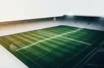 Green-and-white football pitch under stadium lights symbolising Celtic’s rescheduled league fixtures and Europa League schedule.