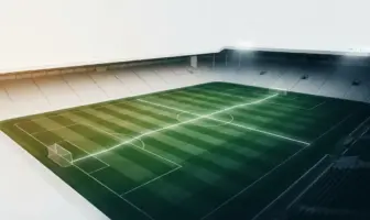 Green-and-white football pitch under stadium lights symbolising Celtic’s rescheduled league fixtures and Europa League schedule.