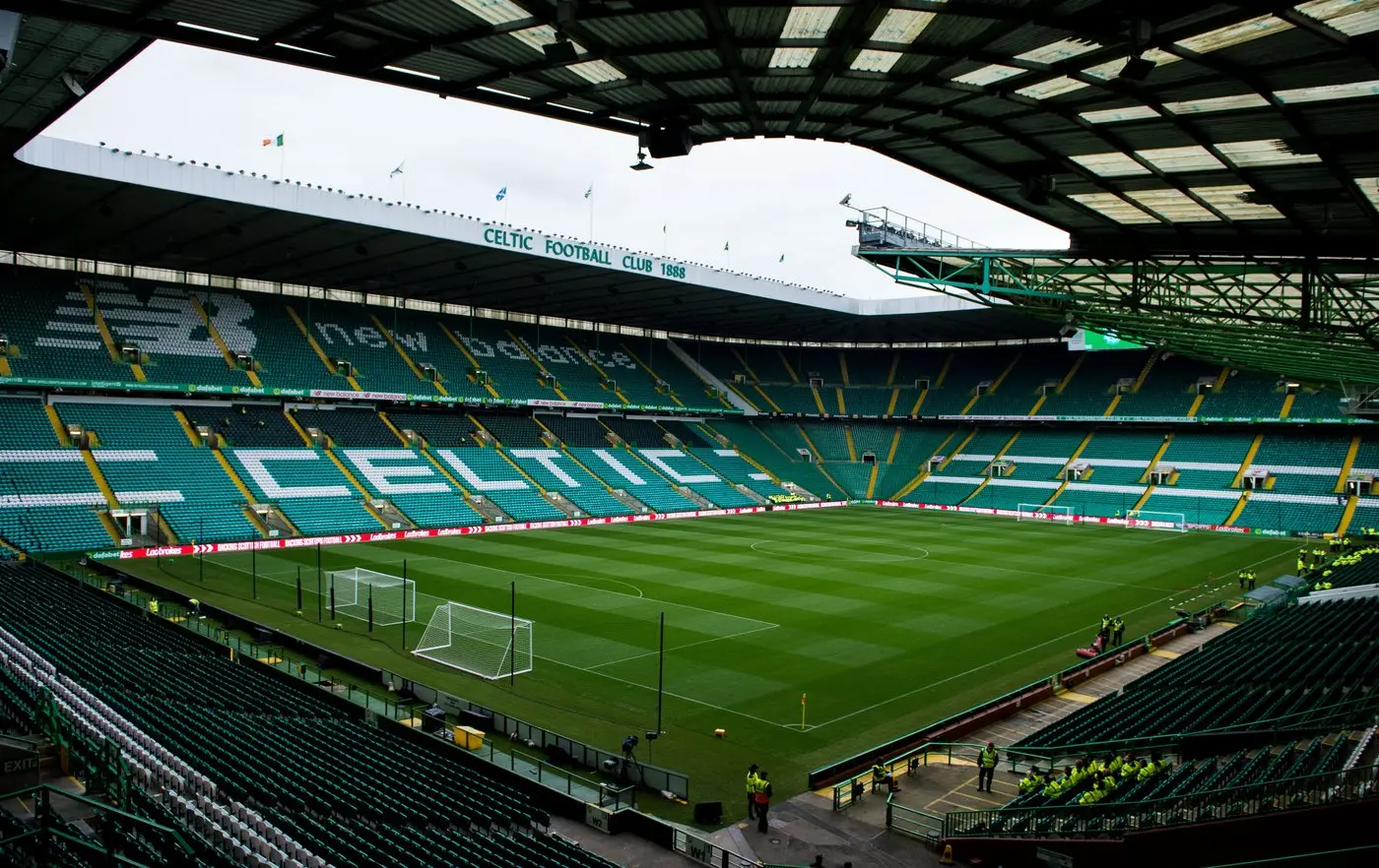 Wide shot of Celtic Park stadium in Glasgow with green seats spelling out CELTIC across the stand