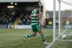 Anonymous Celtic-inspired striker celebrates a decisive penalty-box finish under stadium lights